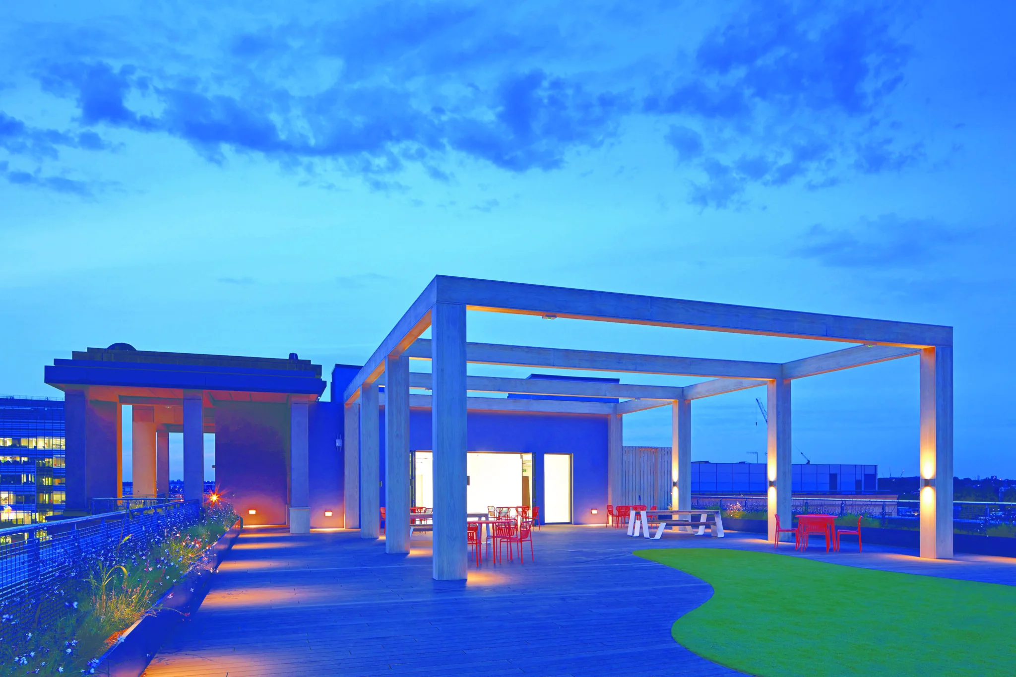 Night view of 1 Queen Caroline Street roof terrace with wooden structure & seating