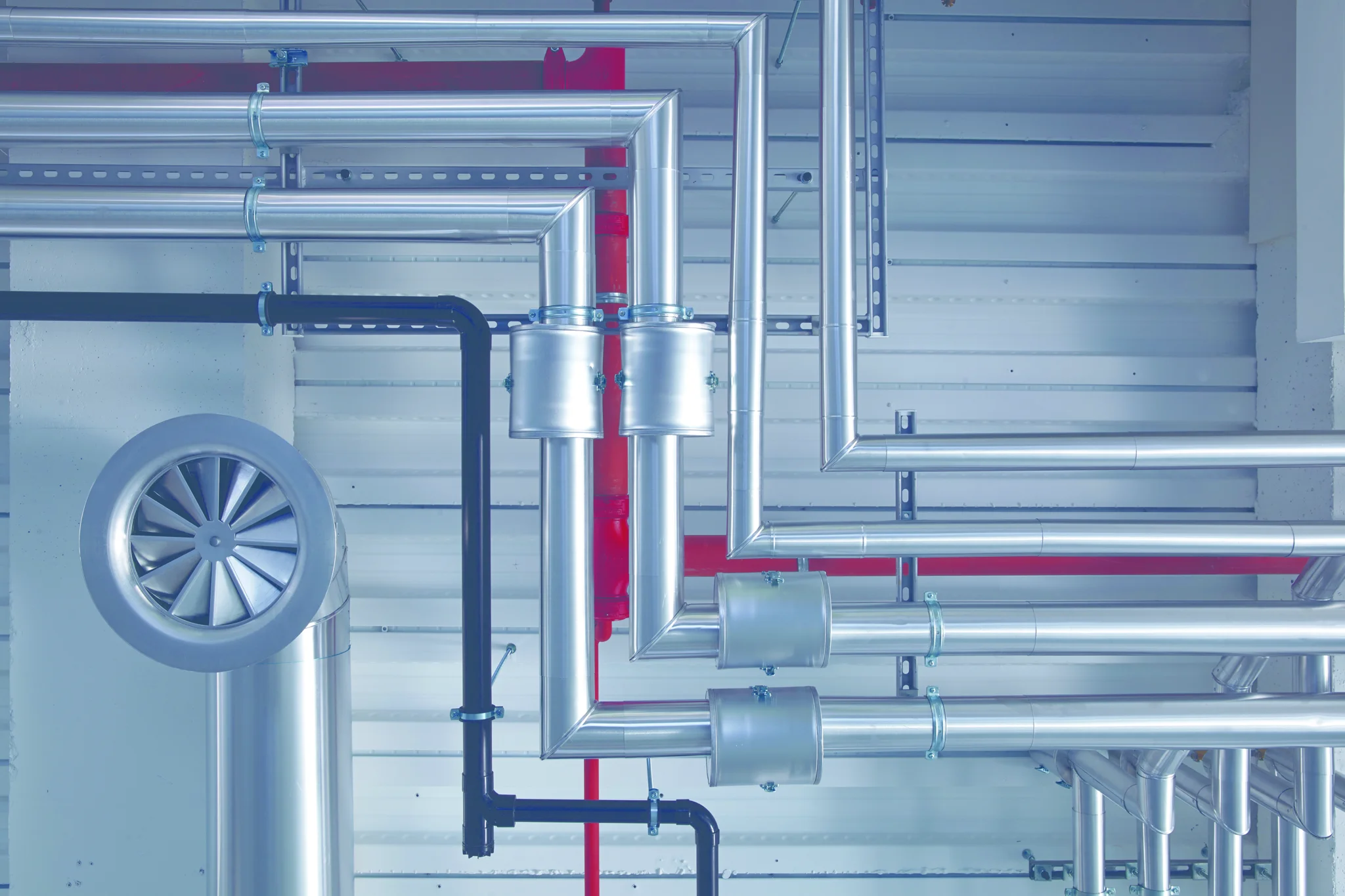 Detail shot of exposed metal pipe work/services in ceiling