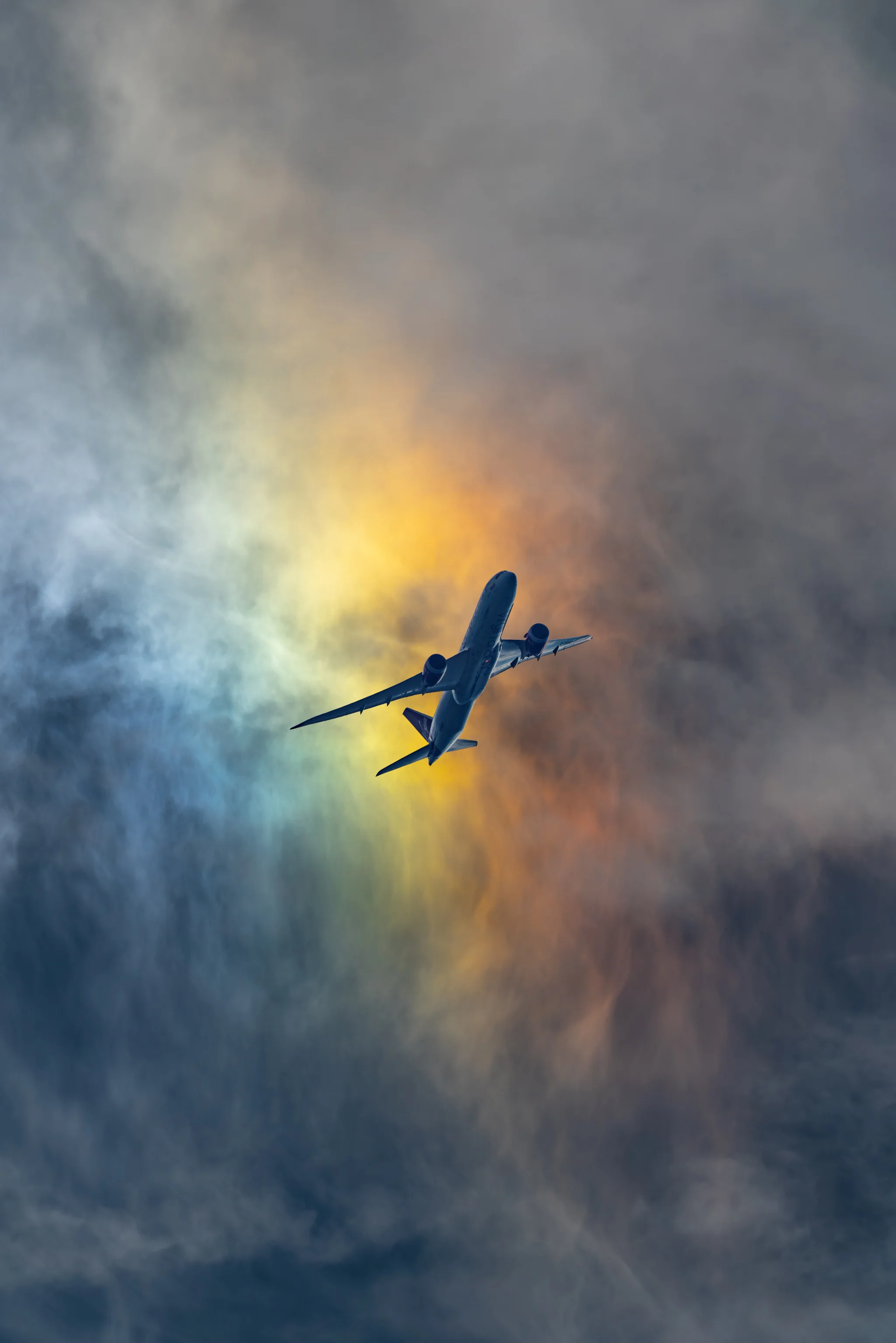 aeroplane flying against a rainbow