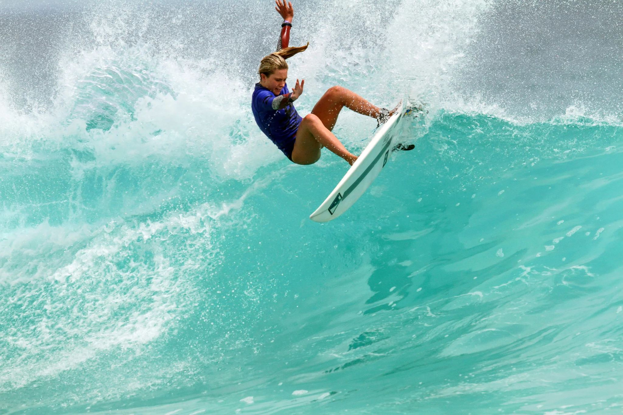 female surfer riding a wave