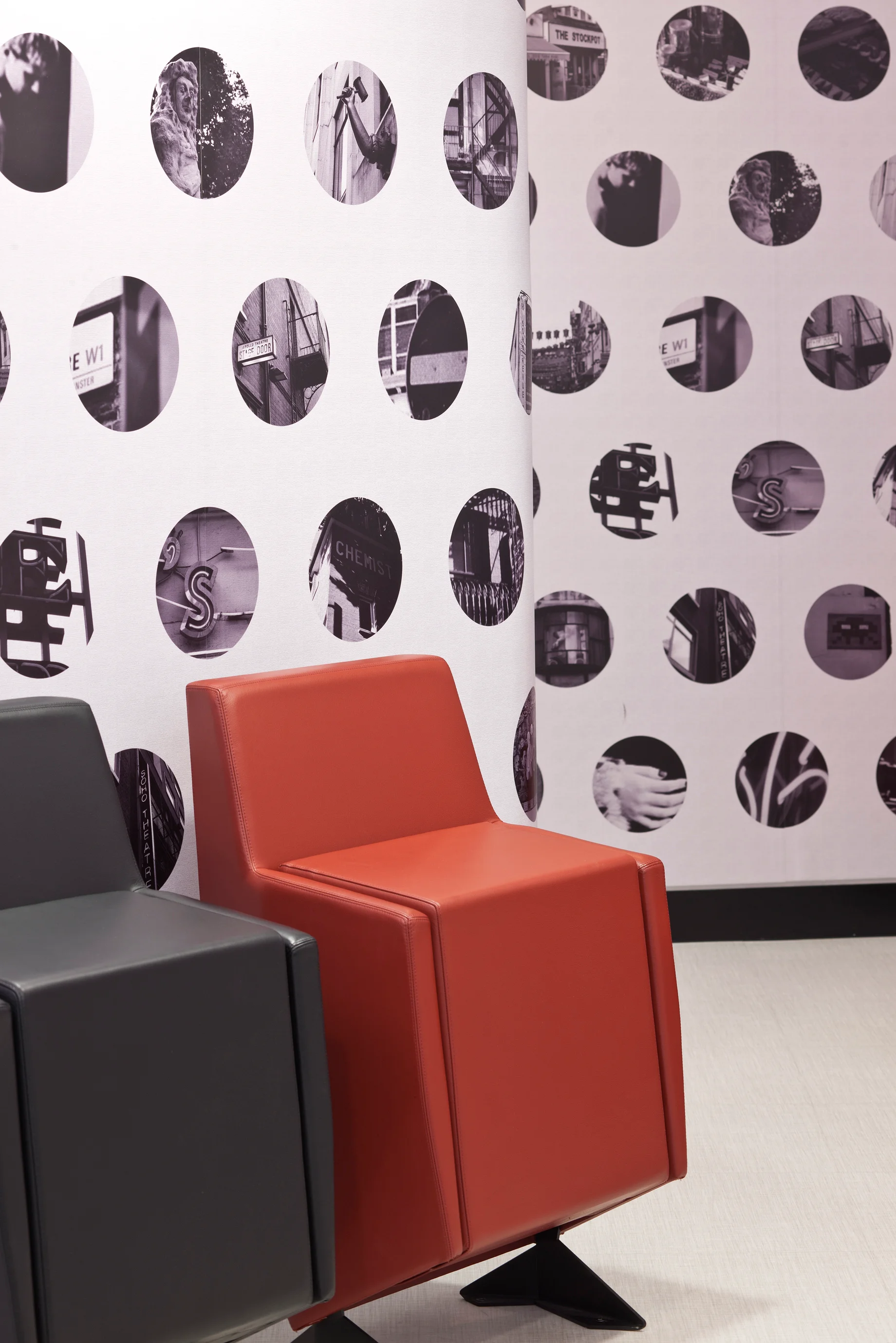 Red and black cinema-style flip chairs against a polka dot and mirrored wall