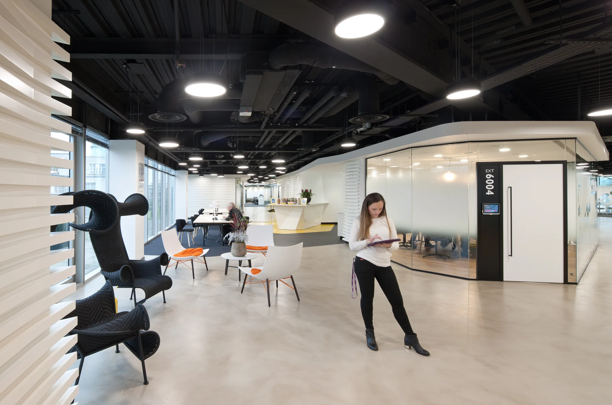 reception area with bright & eclectic seating looking back towards a pick and mix bar & white long table