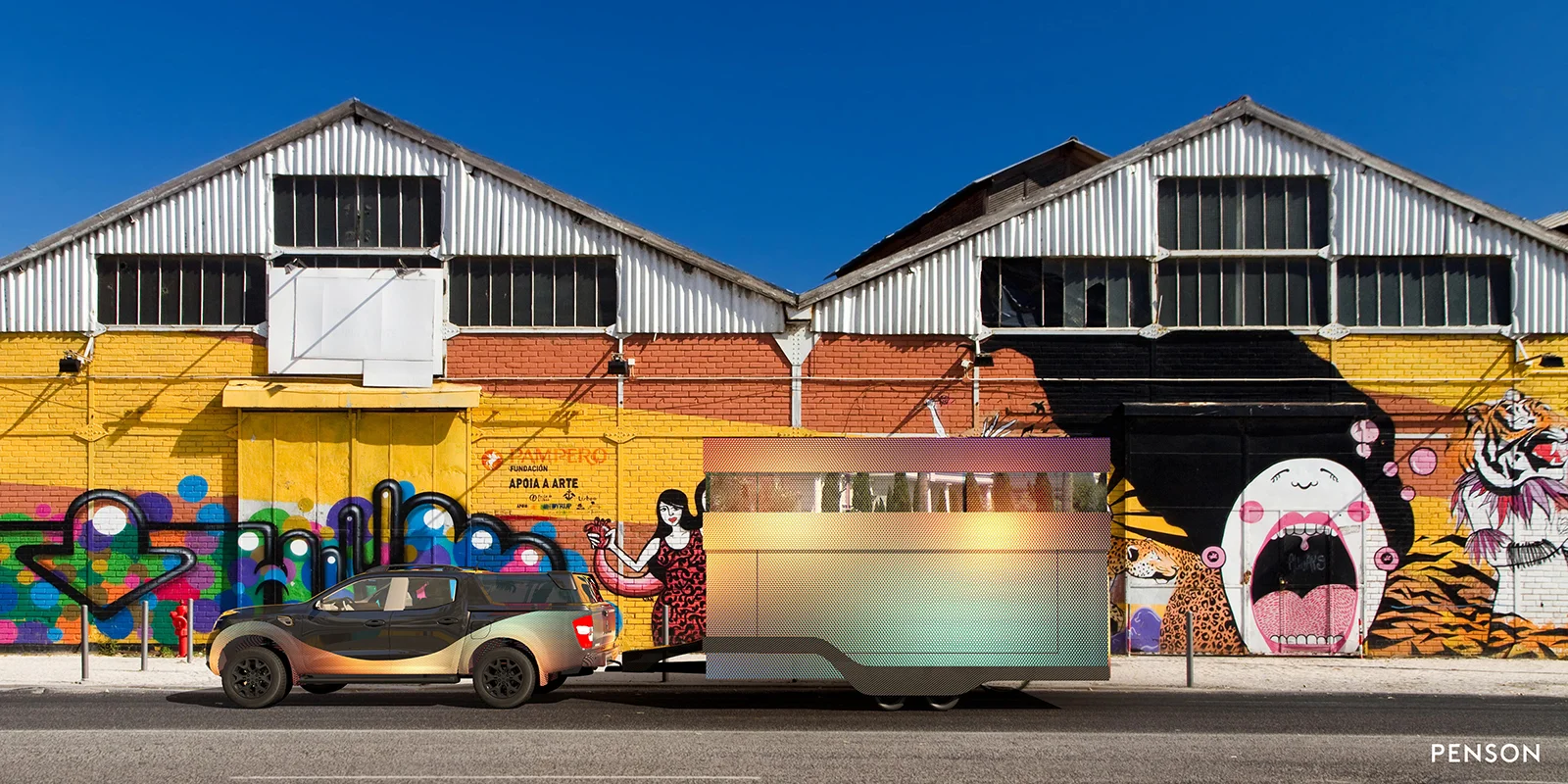 A brightly coloured graffiti street with The Loft parked up on the back of a trailer