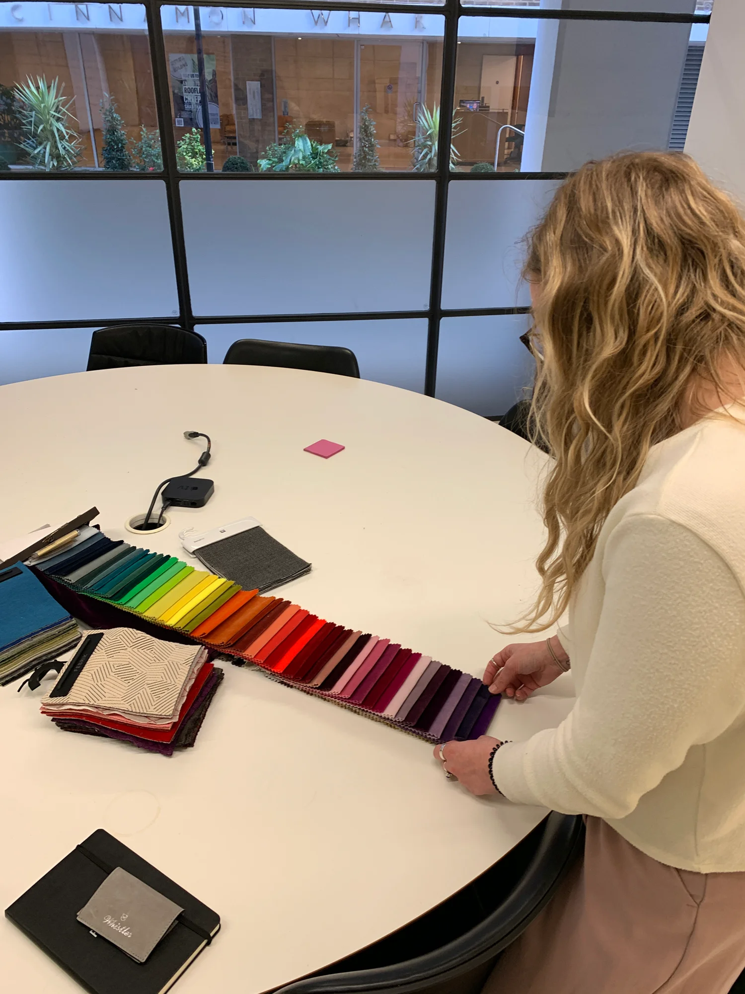 Woman looking at brightly coloured fabric samples