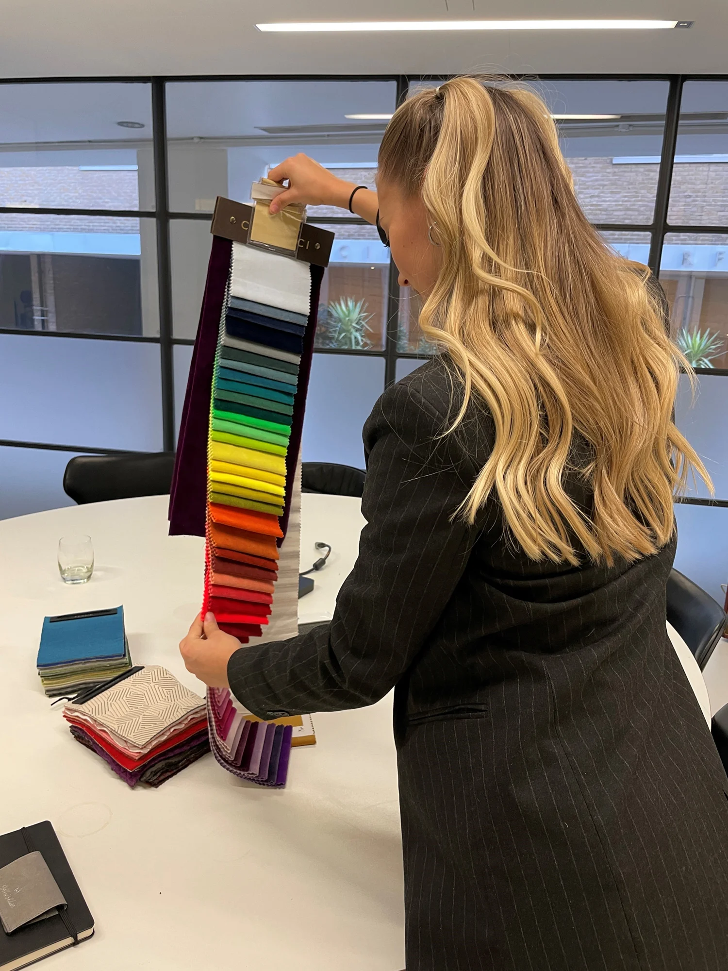 Woman looking at brightly coloured fabric samples
