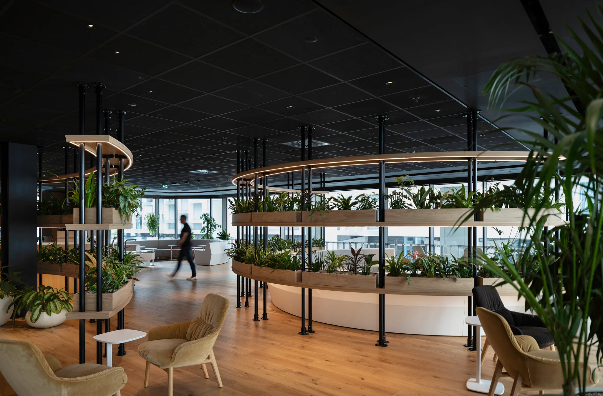 Biophilic workspace with extensive planting and collaborative seating at GSK